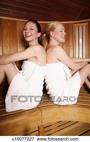 Two young women enjoying a sauna View Large Photo Image Stock Photo - Two young women enjoying a sauna. Fotosearch