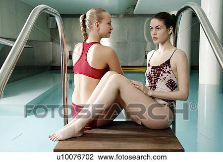 Two young women sitting next to spa pool View Large Photo Image Stock Image - Two young women sitting next to spa pool. Fotosearch