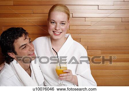 Stock Photograph - A couple having a refreshment after a spa treatment. Fotosearch