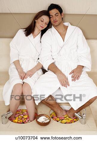 A young couple enjoying a foot bath with rose petals View Large Photo Image Picture - A young couple enjoying a foot bath with rose petals. Fotosearch