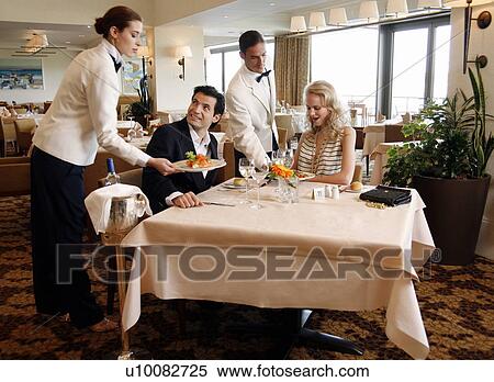 Couple having a romantic moment in a restaurant View Large Photo Image Stock Photography - Couple having a romantic moment in a restaurant. Fotosearch