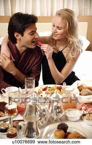 Couple having breakfast in hotel room View Large Photo Image Stock Photo - Couple having breakfast in hotel room. Fotosearch