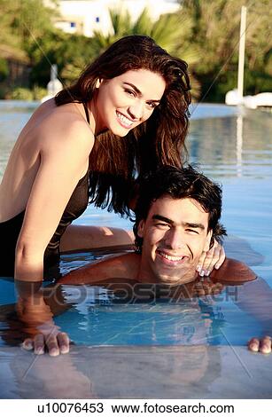 Couple in swimming pool View Large Photo Image Stock Image - Couple in swimming pool. Fotosearch