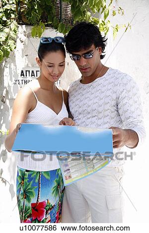 Stock Photograph - Couple looking at map. Fotosearch