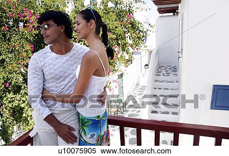 Stock Photography - Couple on a balcony together. Fotosearch
