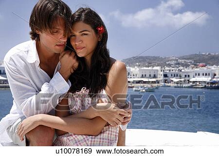 Couple posing with sea view View Large Photo Image Stock Photo - Couple posing with sea view. Fotosearch