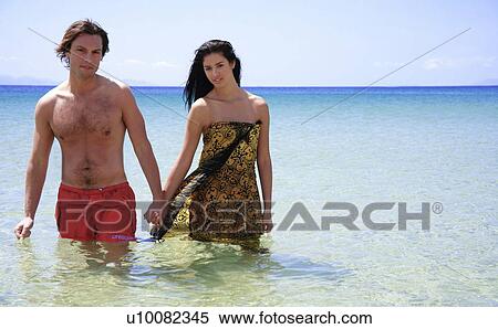 Man and woman holding hands in the water View Large Photo Image Stock Photography - Man and woman holding hands in the water. Fotosearch