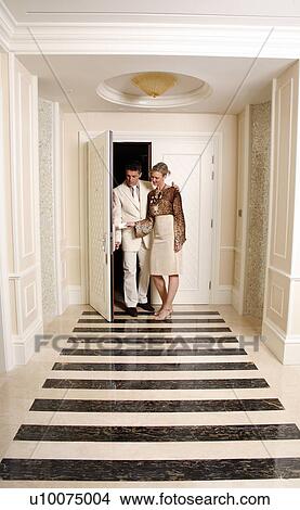 Mature couple entering a hotel suite View Large Photo Image Picture - Mature couple entering a hotel suite. Fotosearch