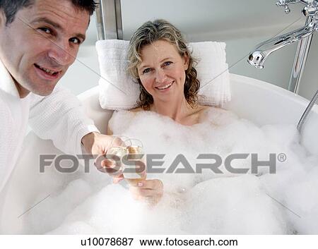 Stock Photo - Mature couple having fun in the bathtub. Fotosearch