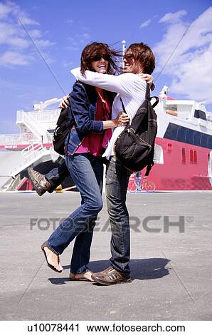 Stock Image - Young couple at ferry dock. Fotosearch