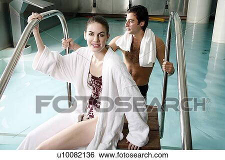Young couple in a swimming pool at a spa View Large Photo Image Stock Photograph - Young couple in a swimming pool at a spa. Fotosearch