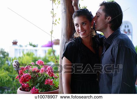 Stock Photo - Young couple on balcony. Fotosearch