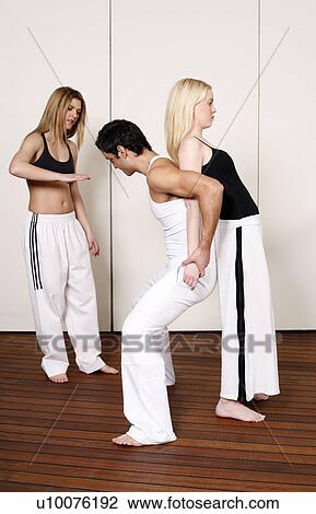Partners practicing flexibility in yoga and Capoeira programs View Large Photo Image Stock Image - Partners practicing flexibility in yoga and Capoeira programs. Fotosearch