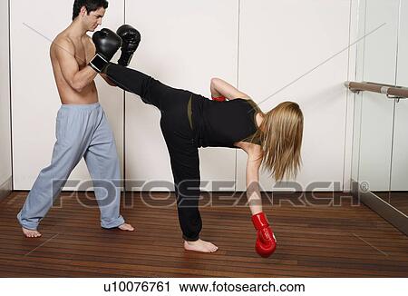 Stock Image - Straight right-hand punch of Active Tae Bo and side kick. Fotosearch