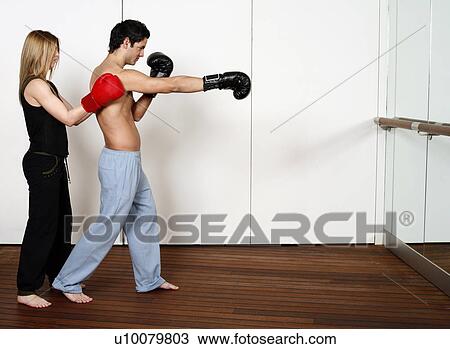 Stock Image - Straight right-hand punch of Active Tae Bo and inside block. Fotosearch