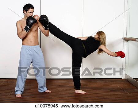 Stock Photography - Straight right-hand punch of Active Tae Bo and side kick. Fotosearch