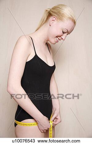 Woman measuring her hips View Large Photo Image Stock Image - Woman measuring her hips. Fotosearch