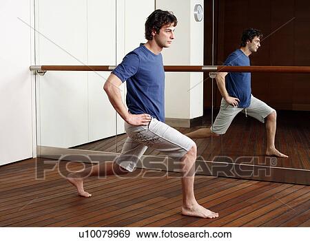 Young man stretching in gym View Large Photo Image Stock Photo - Young man stretching in gym. Fotosearch