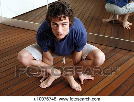 Stock Photo - Young man stretching. Fotosearch