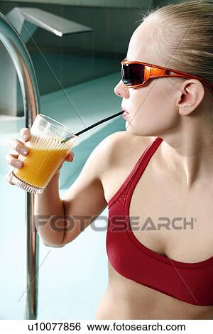 Young woman drinking juice at spa pool View Large Photo Image Stock Photograph - Young woman drinking juice at spa pool. Fotosearch