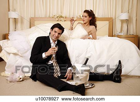Bride and groom toasting in hotel room View Large Photo Image Stock Photo - Bride and groom toasting in hotel room. Fotosearch