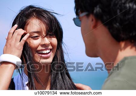 Picture - Closeup of young woman looking at man. Fotosearch
