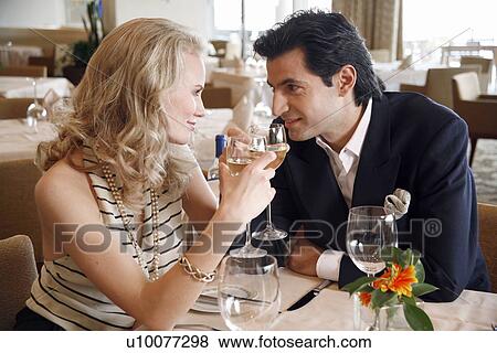 Stock Photo - Couple drinking wine in a restaurant. Fotosearch