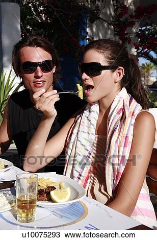 Stock Image - Couple eating at a restaurant. Fotosearch