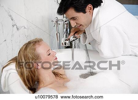 Stock Photo - Couple enjoying bubble bath together. Fotosearch