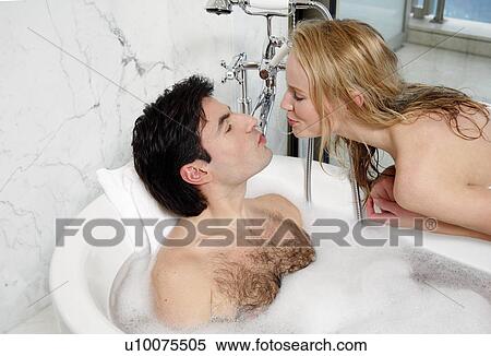 Stock Photography - Couple enjoying bubble bath together. Fotosearch
