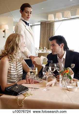 Couple having a romantic moment in a restaurant View Large Photo Image Picture - Couple having a romantic moment in a restaurant. Fotosearch