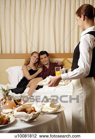 Couple having room service breakfast in hotel room View Large Photo Image Stock Image - Couple having room service breakfast in hotel room. Fotosearch