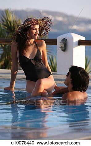 Stock Image - Couple in swimming pool. Fotosearch