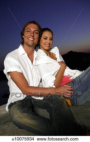Couple sitting on terrace with a view View Large Photo Image Picture - Couple sitting on terrace with a view. Fotosearch