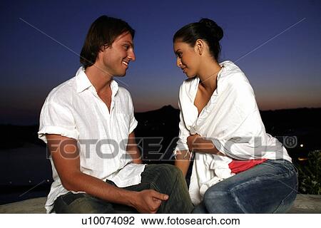 Couple sitting on terrace with a view View Large Photo Image Stock Image - Couple sitting on terrace with a view. Fotosearch