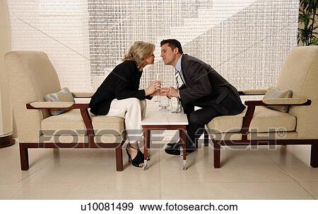 Man and woman sitting in hotel lobby View Large Photo Image Stock Photo - Man and woman sitting in hotel lobby. Fotosearch