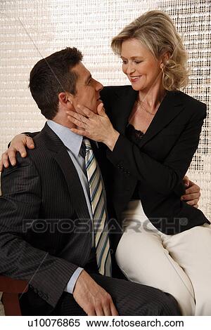 Stock Photography - Man and woman sitting in hotel lobby. Fotosearch