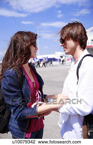 Stock Image - Young couple at ferry dock. Fotosearch