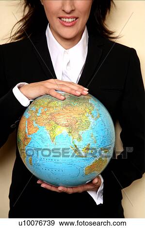A woman holding a globe View Large Photo Image Stock Photo - A woman holding a globe . Fotosearch