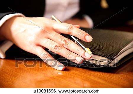 A woman holding an agenda book View Large Photo Image Stock Photograph - A woman holding an agenda book. Fotosearch