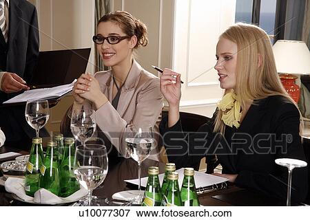 Stock Photo - Business people having a meeting . Fotosearch
