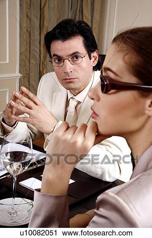 Business people sitting at a conference table View Large Photo Image Stock Image - Business people sitting at a conference table. Fotosearch