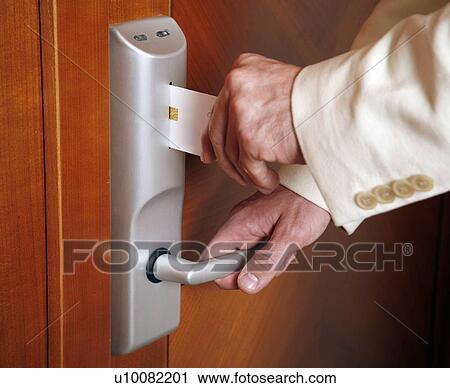 Man Putting Card Key Into Hotel Room Door Stock Image