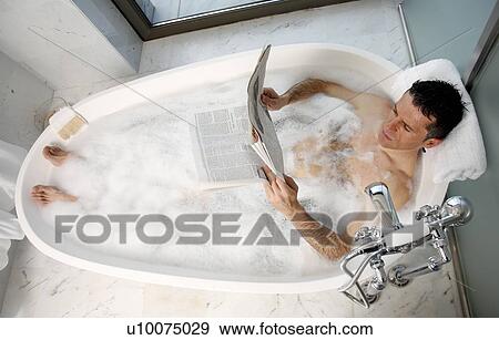Stock Photo - Man relaxing in bathtub with bubbles. Fotosearch