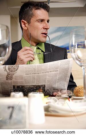 Stock Photograph - Man sitting at the table in a restaurant. Fotosearch
