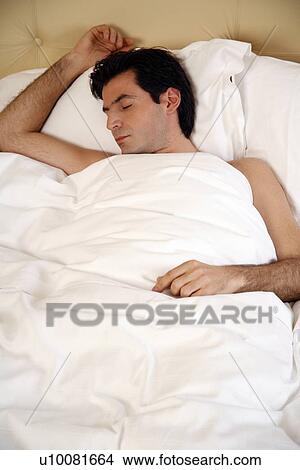 Man sleeping in bed View Large Photo Image Picture - Man sleeping in bed. Fotosearch