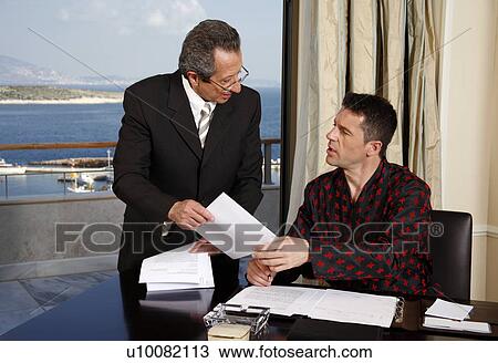 Two businessmen working in a hotel room View Large Photo Image Stock Image - Two businessmen working in a hotel room. Fotosearch