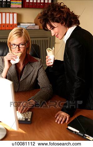 Stock Image - Two women working at the computer. Fotosearch