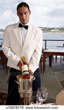 Waiter displaying wine bottle View Large Photo Image Stock Photo - Waiter displaying wine bottle. Fotosearch