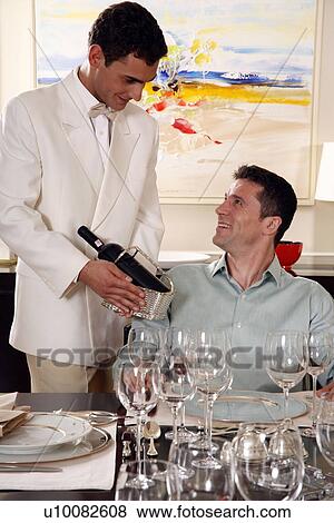 Waiter displaying wine bottle View Large Photo Image Stock Photo - Waiter displaying wine bottle. Fotosearch